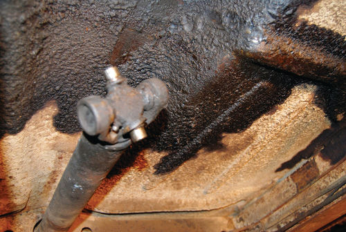 Grease protects metal. The grease from this ball joint protected the dark area, but the area behind the joint has an orange tint that hints of underlying rust.